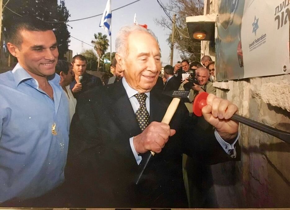 President Shimon Peres, chiseling the cornerstones of the Negev Visitor Center, in 2010